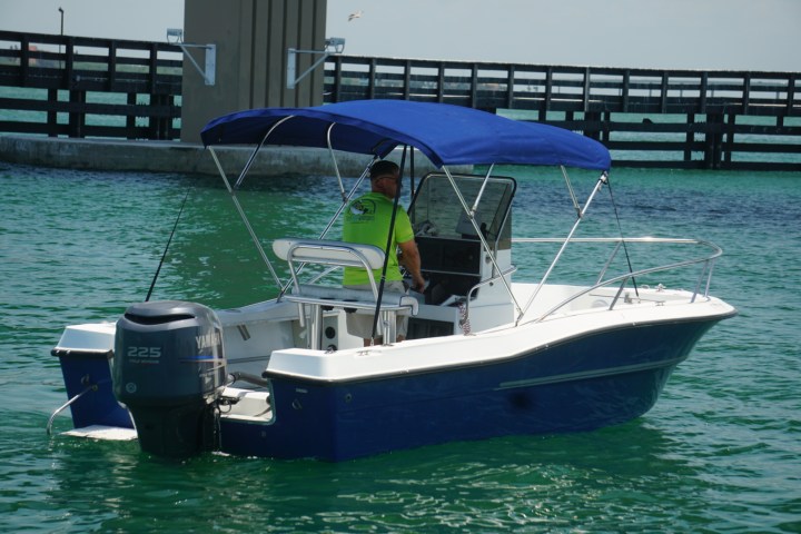 man driving a center console boat in st pete harbor