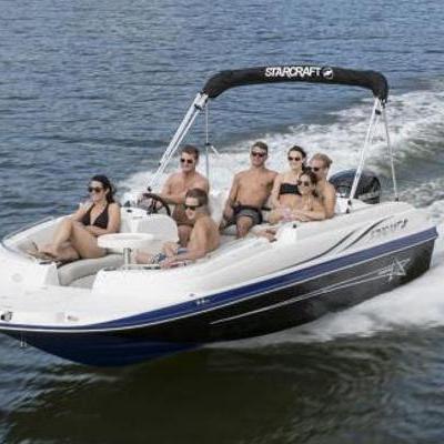 a group of people in a small boat in a body of water